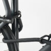 Bügelschloss mit Verlängerung aus schwarzem Textil sichert drei Fahrrad-Komponenten gleichzeitig am Fahrradständer ab