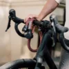 tex-lock orbit in chateau red dangles open over racing bike handlebars with male model in the background
